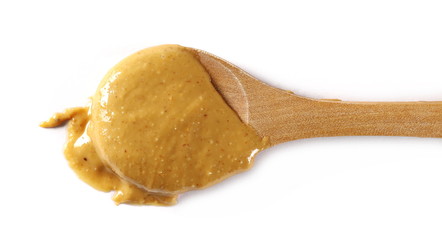 Peanut butter with wooden spoon isolated on white background, top view