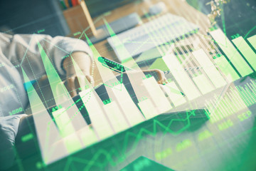 Financial forex charts displayed on woman's hand taking notes background. Concept of research. Double exposure