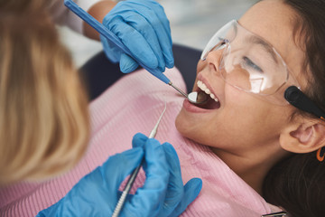 Close up of a nice little girl visiting her stomatologist
