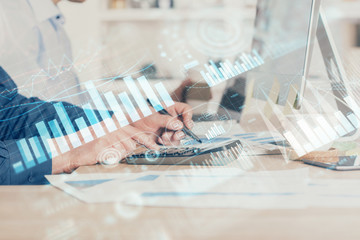 Forex graph with businessman working on computer in office on background. Concept of hardworking. Closeup. Multi exposure.