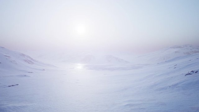 Aerial Landscape of snowy mountains and icy shores in Antarctica