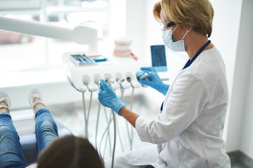 Fototapeta premium Pleasant female dentist going to have an examination
