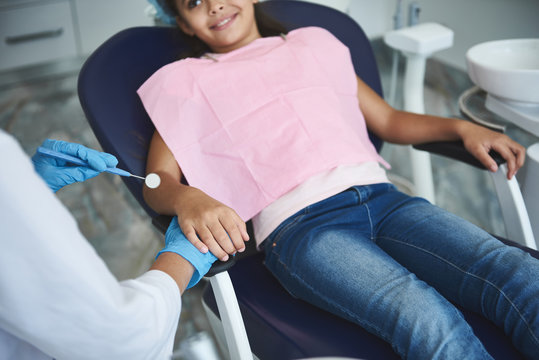 Merry girl is enjoying appointment with dentist
