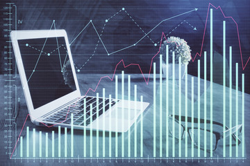Double exposure of graph and financial info and work space with computer background. Concept of international online trading.