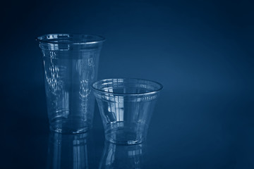 Two fool transparent plastic cups in blue tones.