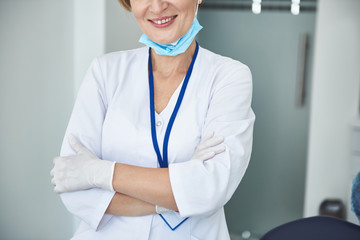 Smiling adult doctor is enjoying working time