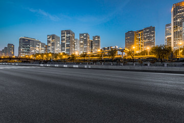 Fototapeta na wymiar Empty asphalt road through modern city in beijing, China