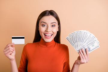 Photo of cheerful charming cute beautiful business woman showing you two ways of payment while...