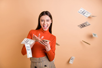 Portrait of her she nice attractive lovely pretty cool cheerful cheery confident straight-haired girl throwing money away isolated over beige pastel color background