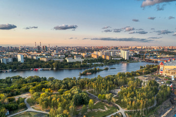 Big city aerial shot. Long and wide streets filled with cars. Shooting in the evening with the setting sun.