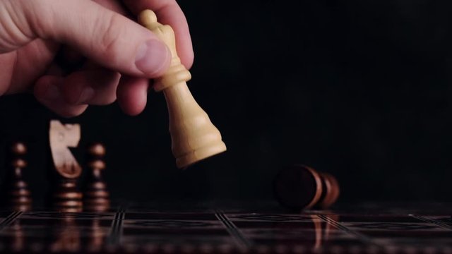 Beating down enemy queen chess figure with king figure