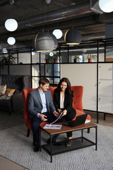 Adult serious man businessman in a business suit discussing business and work with his partner,...