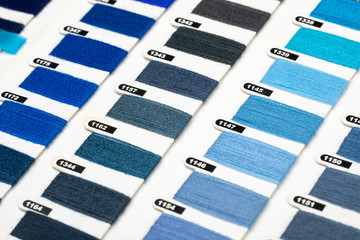 Various blue color hue yarn thread sample swatches close-up