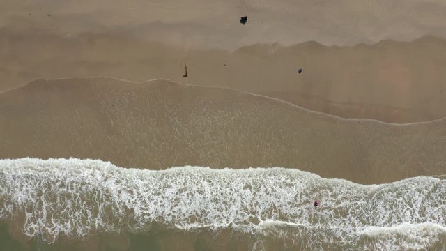 4K Aerial footage view of ocean waves crashing on Beautiful beach by at Sabandar Beach, Tuaran, Sabah, Malaysia