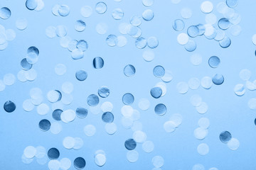 Paper confetti in trendy classic blue shades, on pastel background, top view, selective