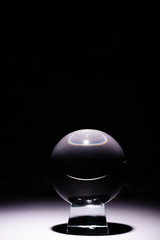 crystal ball on white surface on black background