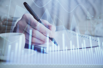 Forex chart displayed on woman's hand taking notes background. Concept of research. Double exposure