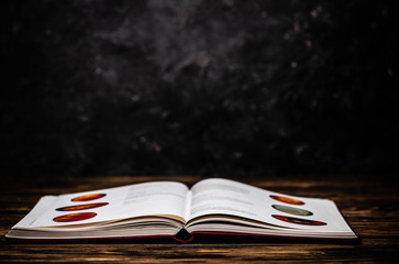 Open astrological book on wooden table