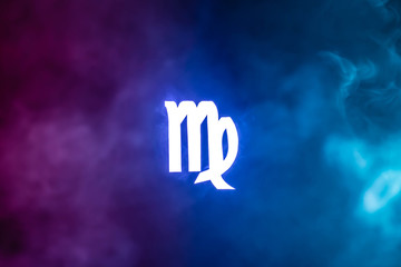 blue illuminated Virgo zodiac sign with colorful smoke on background - obrazy, fototapety, plakaty