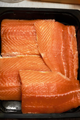 Fresh salmon filet. Salting fresh salmon at home. Salt and sugar used. Blur.
