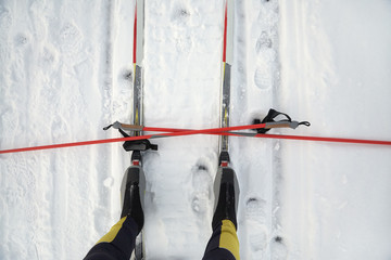 boots and poles on ski track and winter cross-country skiing equipment.