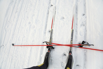 boots and poles on ski track and winter cross-country skiing equipment.
