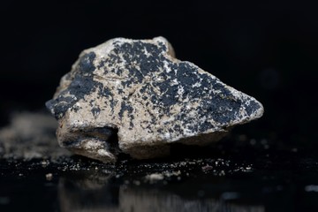 Calcium carbide or calcium acetylide with a black background