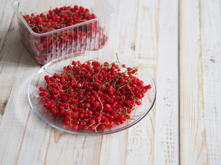 frozen chgoda red currants on a wooden white table