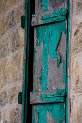 Weathered closed wooden door and stone wall