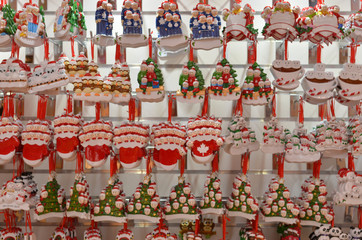 Cute Santa Claus toy dolls key chains placed in a shelf for gifting to during Christmas season in winters. Little Santa figurines are popular gifts for kids during the festivities