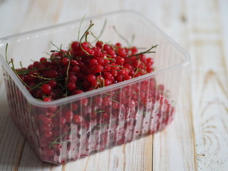 frozen chgoda red currants on a wooden white table