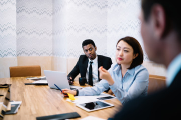 Diverse office colleagues sitting at workplace