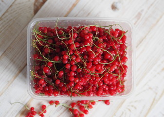 frozen chgoda red currants on a wooden white table