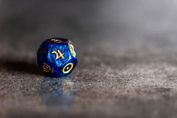 Blue Astrology Dice with symbol of the planet Jupiter on grey background