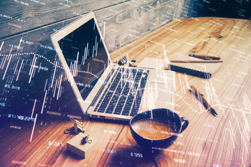 Multi exposure of chart and financial info and work space with computer background. Concept of...