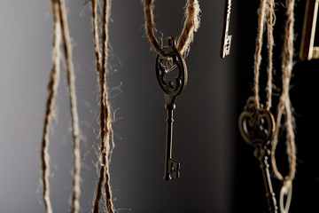 Fototapeta na wymiar close up view of vintage keys hanging on ropes