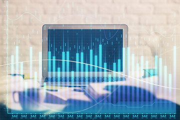 Stock market graph and table with computer background. Multi exposure. Concept of financial analysis.