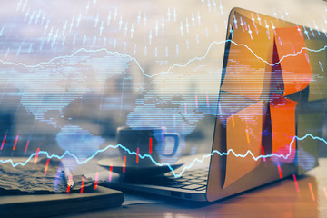 Financial graph colorful drawing and table with computer on background. Multi exposure. Concept of international markets.