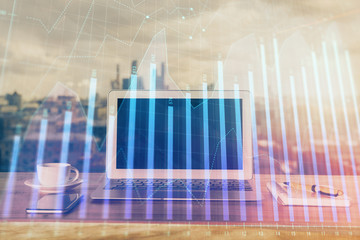 Forex Chart hologram on table with computer background. Multi exposure. Concept of financial...