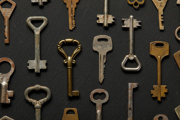 top view of vintage rusty keys on black background