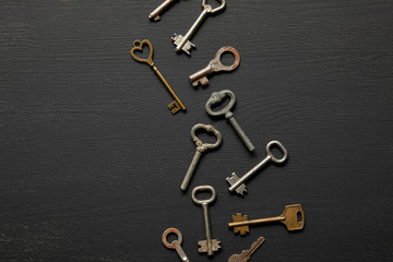 top view of vintage rusty keys on black background