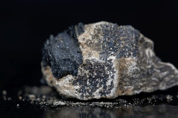 Calcium carbide or calcium acetylide with a black background