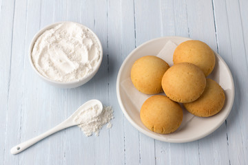 Homemade gluten free cottage cheese rice cookies and bowl rice flour on light background, selective focus. tasty healthy food
