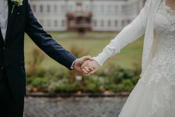 bride and groom holding hands