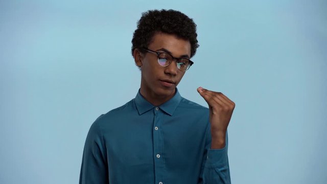 african american teenager showing bla bla gesture isolated on blue