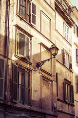Fototapeta na wymiar Windows in an old building with old street light
