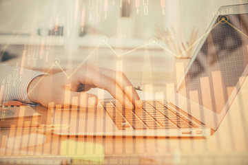 Fototapeta na wymiar Double exposure of stock market graph with man working on laptop on background. Concept of financial analysis.