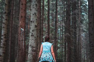 emale figure walking in the forest