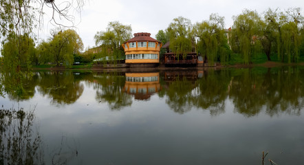 house by the lake or river in the forest