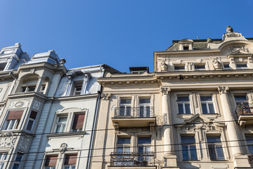 Fototapeta na wymiar Two vintage buildings in a dense urban area with decorative facades